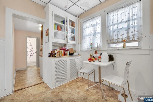 kitchen with a healthy amount of sunlight and glass insert cabinets