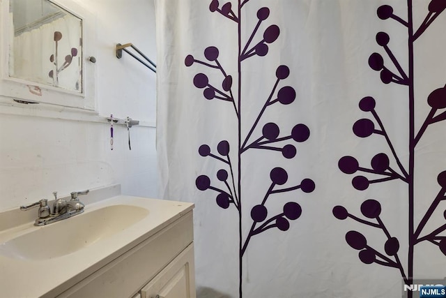 bathroom with curtained shower, vanity, and tile walls