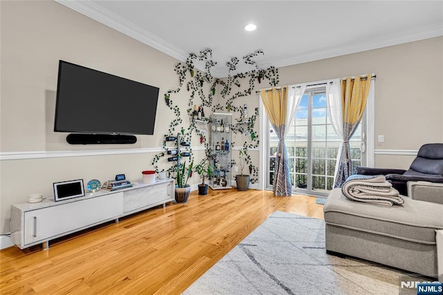 living area with ornamental molding, recessed lighting, and wood finished floors