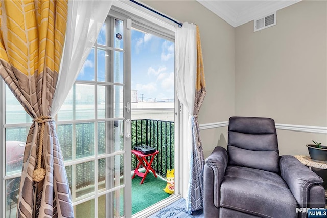 sitting room with visible vents and crown molding