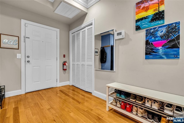 foyer entrance featuring light wood-style floors and baseboards