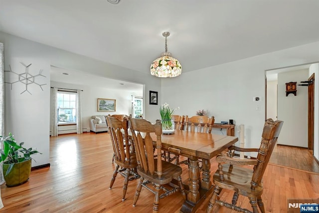 dining space featuring light wood-style floors