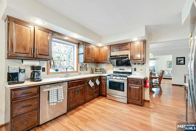 kitchen featuring plenty of natural light, stainless steel appliances, light countertops, and light wood-style floors