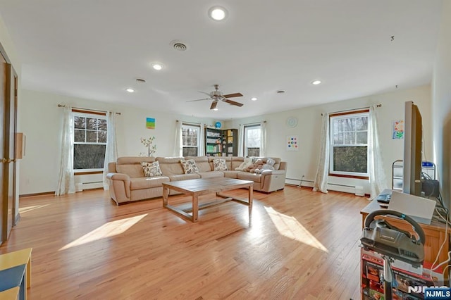 living area with visible vents, recessed lighting, light wood-style floors, a ceiling fan, and a baseboard radiator