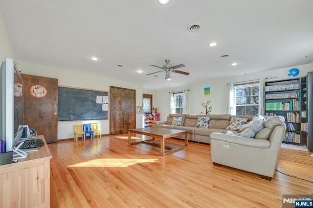 living area with recessed lighting, visible vents, ceiling fan, and light wood finished floors