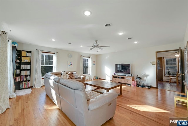 living area featuring recessed lighting, visible vents, light wood-style flooring, and ceiling fan