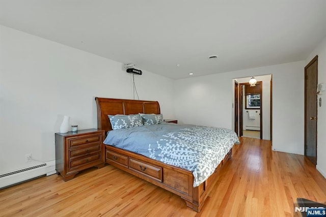 bedroom with light wood-type flooring and a baseboard radiator