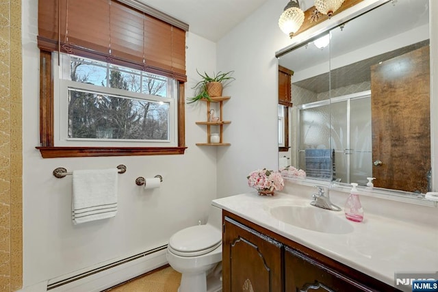 bathroom featuring a baseboard radiator, toilet, a stall shower, and vanity