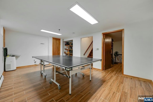 game room featuring baseboards and wood finished floors