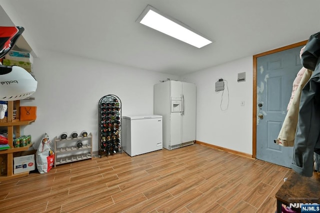 interior space with baseboards and light wood-style floors