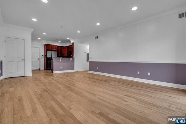 unfurnished living room with crown molding, recessed lighting, baseboards, and light wood-style floors