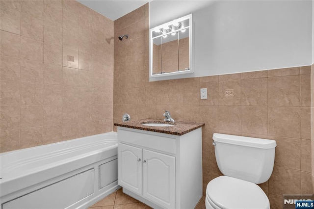 full bathroom with tile patterned floors, tile walls, toilet, and vanity