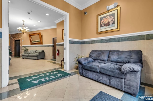 tiled living room with a chandelier, recessed lighting, a wainscoted wall, visible vents, and ornamental molding