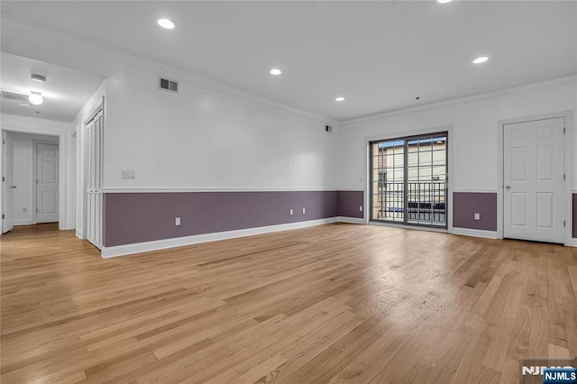 spare room featuring light wood finished floors, visible vents, crown molding, and recessed lighting