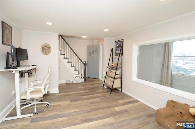 home office with ornamental molding, light wood-type flooring, and baseboards