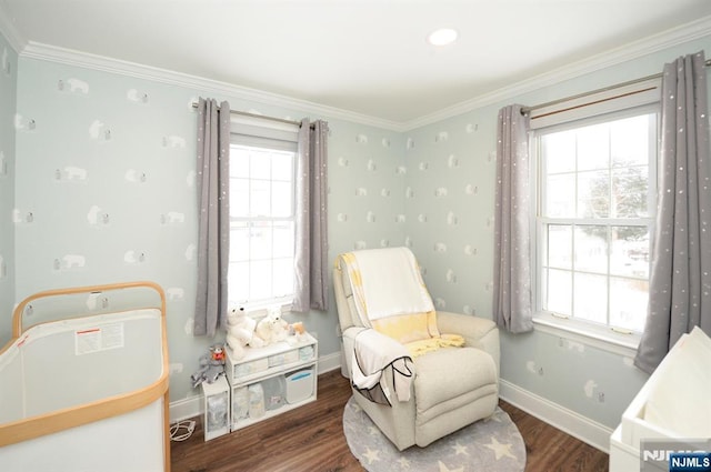 living area with crown molding, wood finished floors, and baseboards