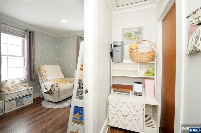 sitting room with baseboards, wood finished floors, and crown molding