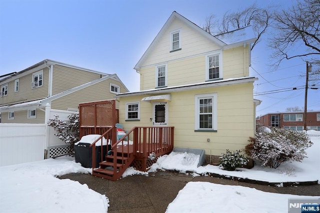 view of front of property featuring fence