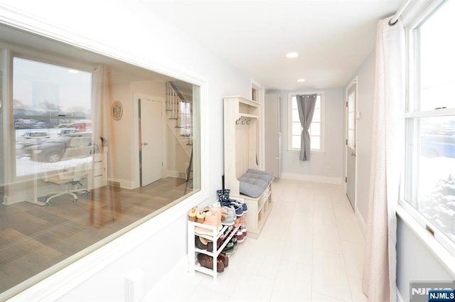 mudroom with recessed lighting and baseboards