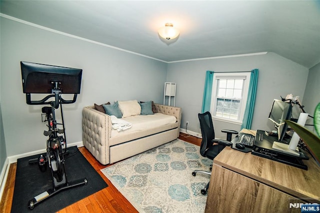 office space with crown molding, baseboards, vaulted ceiling, and wood finished floors