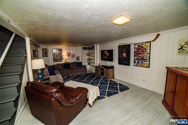 living room featuring baseboards, stairway, a textured ceiling, and tile patterned floors