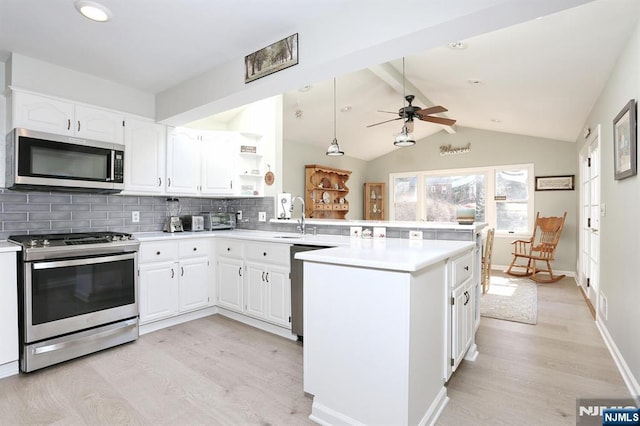 kitchen featuring stainless steel appliances, tasteful backsplash, light wood-style flooring, lofted ceiling with beams, and a peninsula