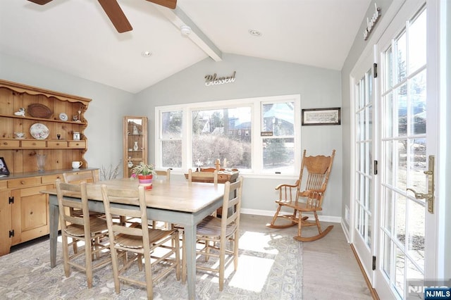 dining room with baseboards, ceiling fan, lofted ceiling with beams, and light wood finished floors