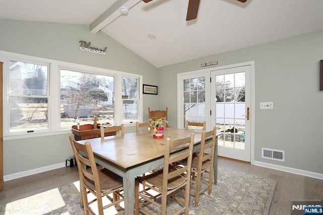 dining space featuring vaulted ceiling with beams, visible vents, ceiling fan, light wood-type flooring, and baseboards