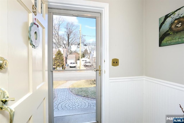 entryway with a wainscoted wall