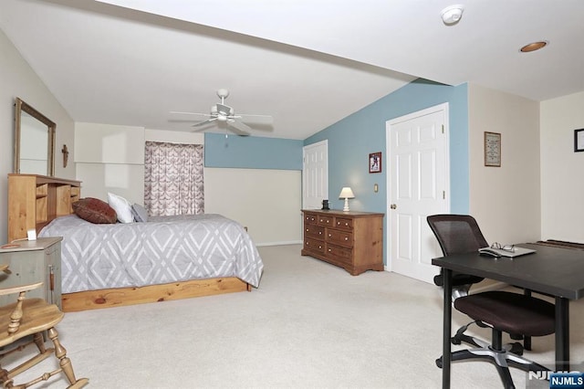 bedroom with ceiling fan, vaulted ceiling, and carpet flooring