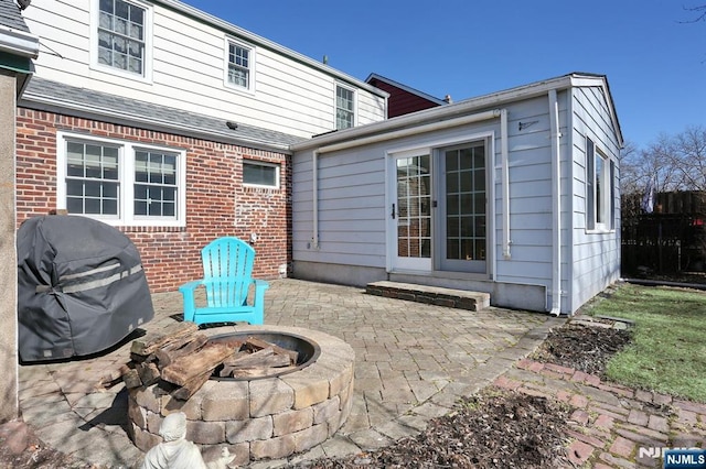 view of patio featuring an outdoor fire pit, area for grilling, and fence