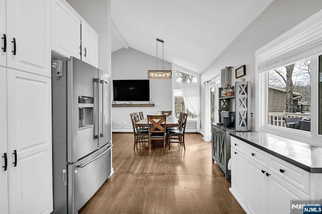 kitchen featuring dark wood-type flooring, a wealth of natural light, white cabinets, and stainless steel fridge with ice dispenser