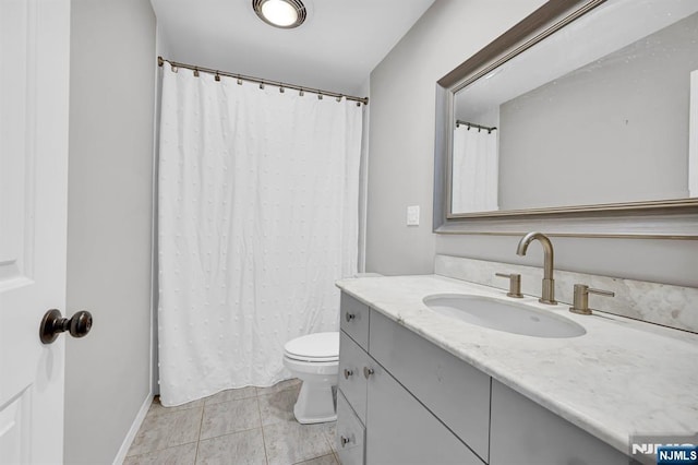 full bath featuring toilet, vanity, and tile patterned floors