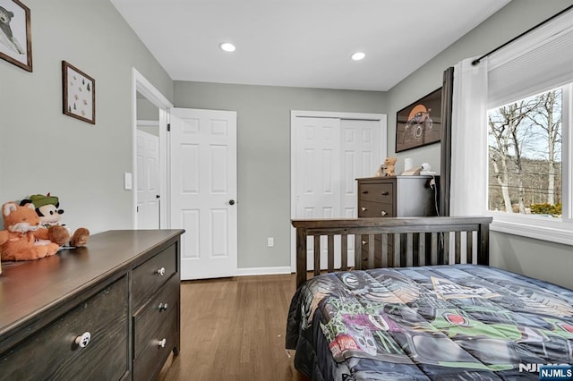 bedroom featuring baseboards, a closet, dark wood finished floors, and recessed lighting