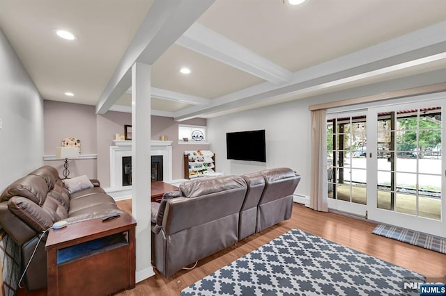 living area featuring a glass covered fireplace, beam ceiling, recessed lighting, and wood finished floors