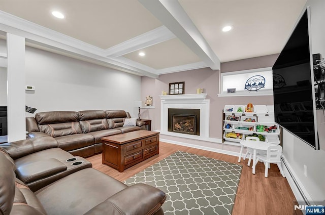 living room with a fireplace with raised hearth, beam ceiling, baseboard heating, and light wood-style flooring