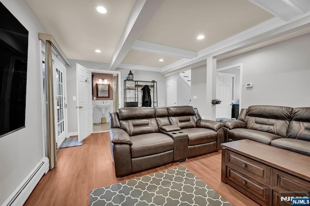 living room featuring a baseboard heating unit, recessed lighting, beam ceiling, and light wood-style floors