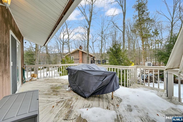 wooden terrace featuring a grill