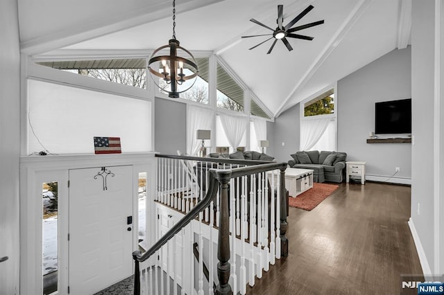 stairs featuring high vaulted ceiling, a baseboard heating unit, wood finished floors, a chandelier, and baseboards