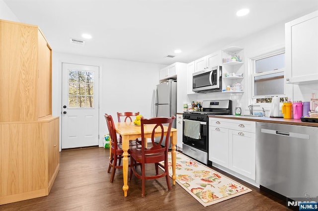 kitchen featuring recessed lighting, dark wood-style flooring, visible vents, white cabinets, and appliances with stainless steel finishes