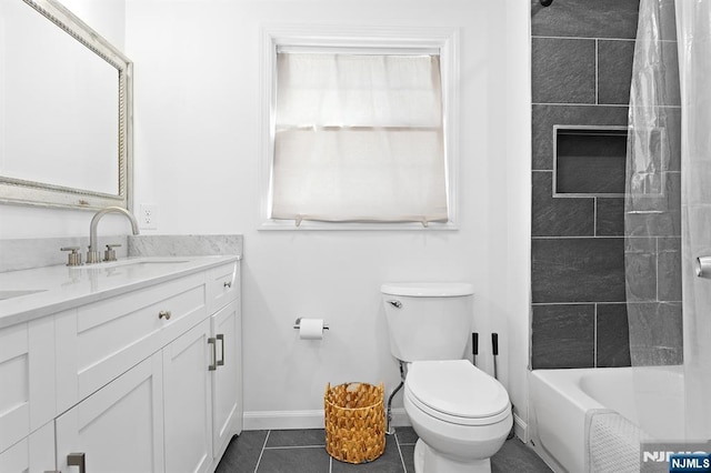 bathroom with baseboards, vanity, toilet, and tile patterned floors