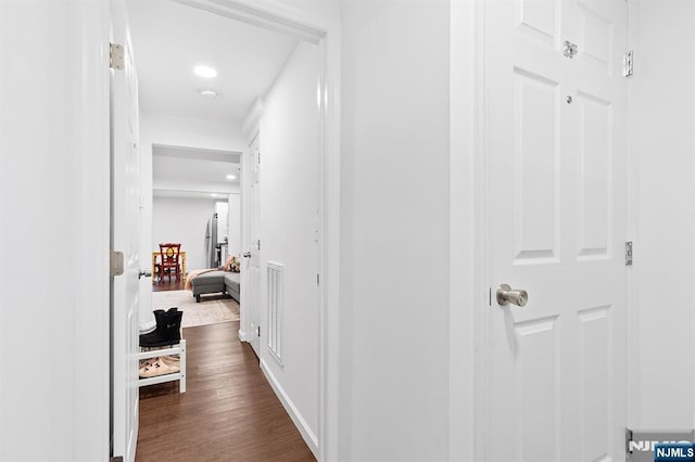 hallway with visible vents and dark wood finished floors