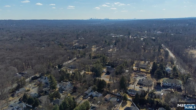 birds eye view of property with a view of trees