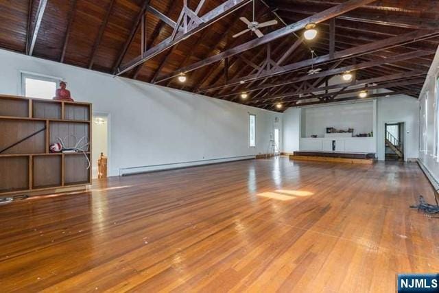 interior space featuring a baseboard heating unit, wood-type flooring, and wooden ceiling