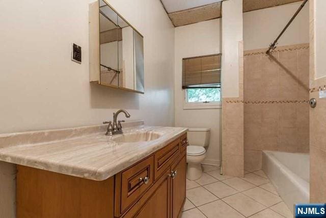 full bath featuring  shower combination, tile patterned flooring, vanity, and toilet