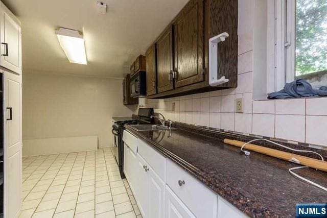 kitchen featuring light tile patterned flooring, white cabinetry, dark brown cabinets, backsplash, and black appliances