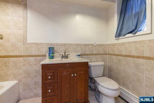 full bathroom featuring a baseboard radiator, tile walls, toilet, and vanity