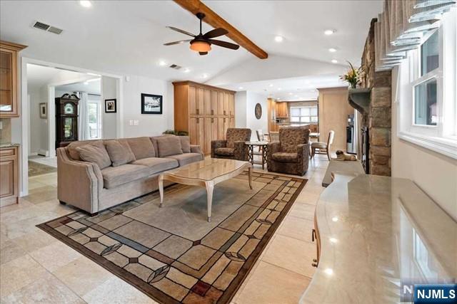 living room with lofted ceiling with beams, a ceiling fan, visible vents, and recessed lighting