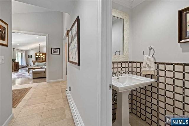 bathroom featuring lofted ceiling and tile patterned flooring