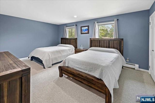 carpeted bedroom featuring baseboards and baseboard heating